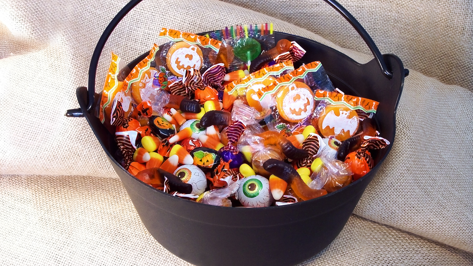 Child's bucket of halloween candy ready for sorting