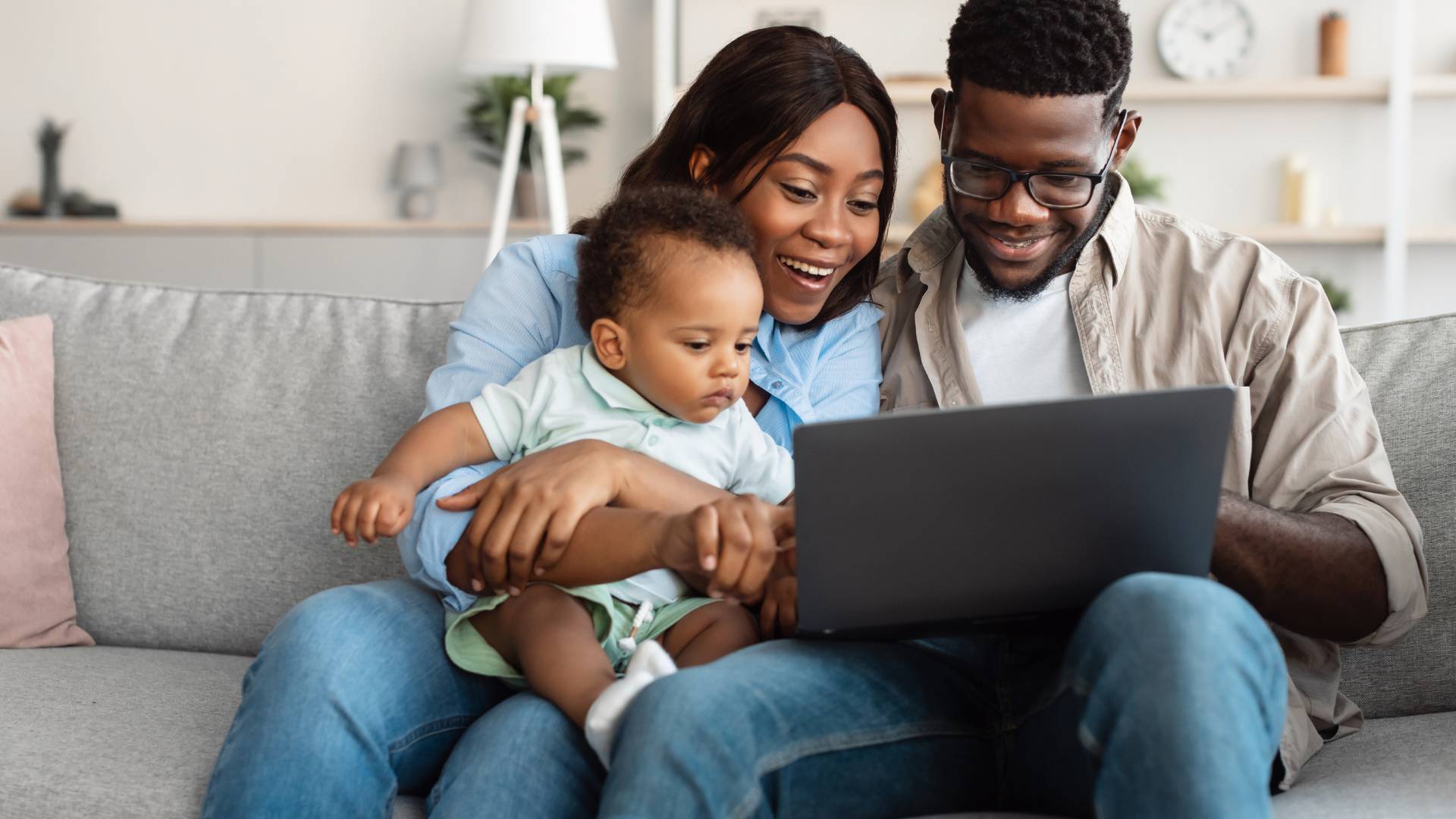 mom, dad, and baby looking at computer for online childbirth classes
